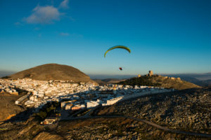 Paragliding over Teba, White village in Andalusia, aerial view, Spain Paragliding over Teba, White village in Andalusia, aerial view, Spain